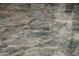 Close-up of the elegant, large-format gray tile flooring, adding a touch of sophistication to the home at 11426 E Quail Ln, Cave Creek, AZ 85331