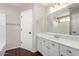 Bathroom featuring white cabinets, quartz countertops, large vanity mirror, and hardwood floors at 11455 E Persimmon Ave, Mesa, AZ 85212