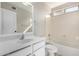 Bright bathroom featuring a shower and tub, white cabinets, quartz countertop and a large mirror at 11455 E Persimmon Ave, Mesa, AZ 85212