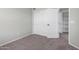 Neutral bedroom boasts carpet flooring, sliding closet doors, and white trim at 11455 E Persimmon Ave, Mesa, AZ 85212