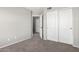 Spacious bedroom with plush carpet, sliding closet, and adjoining room at 11455 E Persimmon Ave, Mesa, AZ 85212