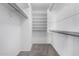 Walk-in closet featuring built-in shelving, ample storage space, and carpet flooring at 11455 E Persimmon Ave, Mesa, AZ 85212