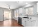 Kitchen with white cabinets, stainless steel dishwasher, and a sliding glass door to the backyard at 11455 E Persimmon Ave, Mesa, AZ 85212