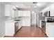 Modern kitchen with stainless steel appliances, white cabinets, quartz countertops, and hardwood floors at 11455 E Persimmon Ave, Mesa, AZ 85212