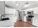 Kitchen featuring stainless steel appliances, white cabinets, and laminate countertops at 11455 E Persimmon Ave, Mesa, AZ 85212