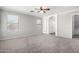 Spacious main bedroom showcasing two large windows, a ceiling fan, and a closet at 11455 E Persimmon Ave, Mesa, AZ 85212