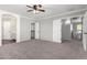 Spacious main bedroom with neutral carpet, ceiling fan, and an ensuite bathroom at 11455 E Persimmon Ave, Mesa, AZ 85212