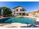 Backyard pool with pristine water, set against a backdrop of an exterior elevation and lush greenery at 11455 E Persimmon Ave, Mesa, AZ 85212