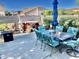 Backyard featuring an outdoor dining set, jacuzzi, hardscape, and privacy fencing at 12027 W Morning Dove Dr, Sun City, AZ 85373