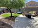 Well-maintained backyard featuring artificial grass, mature tree, and lounge area at 12027 W Morning Dove Dr, Sun City, AZ 85373