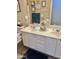 Bathroom featuring double sinks, white cabinets, and decorative accents with sea shells at 12027 W Morning Dove Dr, Sun City, AZ 85373