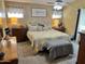 Comfortable bedroom with yellow tones, large bed, and side tables at 12027 W Morning Dove Dr, Sun City, AZ 85373