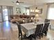 Inviting dining room with a large table, seating for six, and a view into the living area at 12027 W Morning Dove Dr, Sun City, AZ 85373