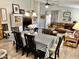 Spacious dining area with a table for six and view to living room with a comfortable sectional sofa at 12027 W Morning Dove Dr, Sun City, AZ 85373