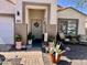 Inviting front entrance with decorative potted plants and a 'Welcome' sign at 12027 W Morning Dove Dr, Sun City, AZ 85373
