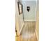 Bright hallway featuring wood-look floors, neutral walls, and access to other rooms at 12027 W Morning Dove Dr, Sun City, AZ 85373