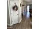 Hallway view featuring decorative door with wood-look floors that transition into the living and dining areas at 12027 W Morning Dove Dr, Sun City, AZ 85373