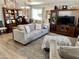 Well-lit living room featuring a large sofa, and matching furniture with neutral tones at 12027 W Morning Dove Dr, Sun City, AZ 85373