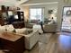 Cozy living room with comfortable seating, built-in shelving, and a large TV at 12027 W Morning Dove Dr, Sun City, AZ 85373