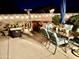 Evening view of a patio featuring an outdoor dining set, patio heater, and spa at 12027 W Morning Dove Dr, Sun City, AZ 85373