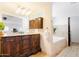 Luxurious bathroom features a large vanity with dual sinks, modern fixtures, and a standalone tub at 12210 N 67Th St, Scottsdale, AZ 85254