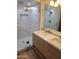 Beautiful bathroom featuring a double sink vanity with stone countertops and a glass enclosed shower at 12210 N 67Th St, Scottsdale, AZ 85254