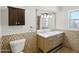 Bathroom with double vanity, tile accents, and dark wood cabinet at 12210 N 67Th St, Scottsdale, AZ 85254
