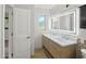 Bright bathroom featuring double sinks, an illuminated mirror, and contemporary fixtures at 12210 N 67Th St, Scottsdale, AZ 85254