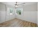 Bright bedroom with wood floors, plantation shutters, and decorative wainscoting at 12210 N 67Th St, Scottsdale, AZ 85254