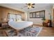 Cozy bedroom featuring a decorative rug, a leather chair, and natural light from the windows at 12210 N 67Th St, Scottsdale, AZ 85254