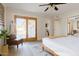 Bright bedroom with a sliding glass door, a ceiling fan, and a comfortable bed at 12210 N 67Th St, Scottsdale, AZ 85254