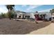 Charming home featuring an eye-catching front yard with flower beds and unique landscaping at 12210 N 67Th St, Scottsdale, AZ 85254