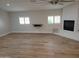 Bright, spacious living room featuring a fireplace, ceiling fan and natural light from the window at 12210 N 67Th St, Scottsdale, AZ 85254