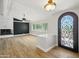 Open concept living room with fireplace and modern light fixtures and a decorative front door at 12210 N 67Th St, Scottsdale, AZ 85254