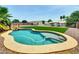 Backyard oasis with refreshing pool, green turf and shaded pergola; ideal for outdoor enjoyment at 12210 N 67Th St, Scottsdale, AZ 85254