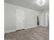 Bright bedroom showcases updated flooring, neutral paint, and multiple doors for easy access at 12438 W Flores Dr, El Mirage, AZ 85335