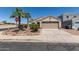 Charming single-story home featuring a two-car garage and low maintenance desert landscaping at 12438 W Flores Dr, El Mirage, AZ 85335