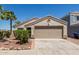 Attractive single-story home with a well-maintained front yard and neutral color palette at 12438 W Flores Dr, El Mirage, AZ 85335