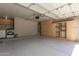 Spacious garage featuring built-in storage cabinets and an included washer and dryer at 12438 W Flores Dr, El Mirage, AZ 85335