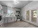 Well-lit kitchen featuring stainless appliances, gray cabinets, and access to the backyard at 12438 W Flores Dr, El Mirage, AZ 85335