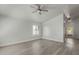 Spacious living area with plank flooring, neutral paint, and lots of natural light at 12438 W Flores Dr, El Mirage, AZ 85335