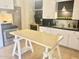 Modern kitchen featuring stainless steel appliances, white cabinets, and light wood table at 1309 W 10Th St, Tempe, AZ 85281