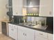 Modern kitchen featuring stainless steel appliances, white cabinets, and dark countertops at 1309 W 10Th St, Tempe, AZ 85281