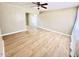 Bright living room featuring wood floors, neutral walls, ceiling fan, and ample natural light from large windows at 1309 W 10Th St, Tempe, AZ 85281