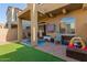 Private backyard featuring covered patio and a low maintenance artificial grass area at 1350 S Greenfield Rd # 1040, Mesa, AZ 85206