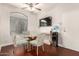 Elegant dining area with a glass table, stylish chairs, and hardwood floors at 1350 S Greenfield Rd # 1040, Mesa, AZ 85206