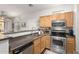 Well-equipped kitchen with stainless steel appliances and wooden cabinets at 1350 S Greenfield Rd # 1040, Mesa, AZ 85206