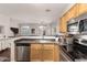 Well lit kitchen boasts stainless steel appliances, ample counter space, and a large sink at 1350 S Greenfield Rd # 1040, Mesa, AZ 85206