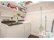 Functional laundry room with modern washer and dryer units and shelving at 1350 S Greenfield Rd # 1040, Mesa, AZ 85206