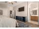 Spacious main bedroom featuring mounted tv and en suite bathroom access at 1350 S Greenfield Rd # 1040, Mesa, AZ 85206